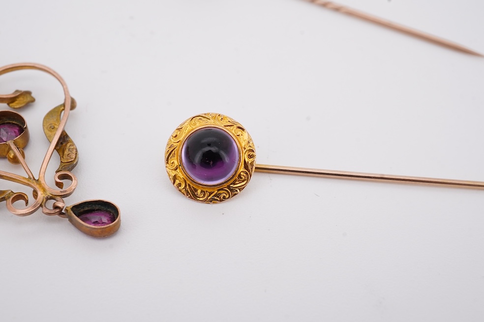 An Edwardian 15ct, diamond and seed pearl cluster set stick pin, 54mm, a similar yellow metal and cabochon garnet set stick pin and an Edwardian 9ct and gem set drop pendant. Condition - poor to fair